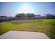 Wide shot of a backyard with a wooden fence and green grass at 8021 Wesley Farm Dr, Raleigh, NC 27616