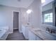 Bathroom with granite countertops, dual vanity, and stylish mirror lighting at 8021 Wesley Farm Dr, Raleigh, NC 27616