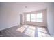 Sunlit bedroom with multiple windows and light gray floors at 8021 Wesley Farm Dr, Raleigh, NC 27616