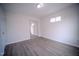 Bright bedroom with modern sliding mirror closet doors and light gray floors at 8021 Wesley Farm Dr, Raleigh, NC 27616