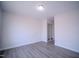 An interior shot of a bedroom with light gray walls and matching wood-look floors at 8021 Wesley Farm Dr, Raleigh, NC 27616