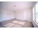 Bright, airy bedroom with light gray floors and natural light from the window at 8021 Wesley Farm Dr, Raleigh, NC 27616