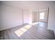 Bedroom with gray floors, ample natural light, and a large closet with mirrored doors at 8021 Wesley Farm Dr, Raleigh, NC 27616