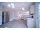 Modern kitchen featuring stainless steel appliances, gray cabinets, and a connecting dining area at 8021 Wesley Farm Dr, Raleigh, NC 27616