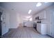 Spacious kitchen with gray cabinets, stainless steel appliances, and hardwood floors at 8021 Wesley Farm Dr, Raleigh, NC 27616