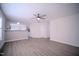 Open-concept living room featuring hardwood floors, a ceiling fan, and an eat-in kitchen at 8021 Wesley Farm Dr, Raleigh, NC 27616