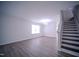 Open living space with hardwood floors, a chandelier, and large windows at 8021 Wesley Farm Dr, Raleigh, NC 27616