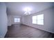Large living room featuring hardwood floors, a ceiling fan, and ample natural light at 8021 Wesley Farm Dr, Raleigh, NC 27616
