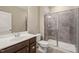 Bathroom with a sleek vanity, toilet, and glass-enclosed shower with modern tile at 900 Green Oaks Pkwy, Holly Springs, NC 27540