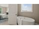 A soaking tub is set in front of a window at 900 Green Oaks Pkwy, Holly Springs, NC 27540