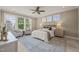 This bedroom boasts lots of natural light, neutral walls, and a ceiling fan at 900 Green Oaks Pkwy, Holly Springs, NC 27540