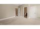 Neutral bedroom featuring doors to an adjacent room and a bathroom at 900 Green Oaks Pkwy, Holly Springs, NC 27540