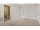 Cozy bedroom featuring soft carpeting, neutral walls, and doorways to adjacent rooms at 900 Green Oaks Pkwy, Holly Springs, NC 27540