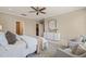 Bedroom with two sitting chairs, a large rug, and a white dresser at 900 Green Oaks Pkwy, Holly Springs, NC 27540