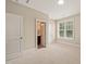 Comfortable bedroom with bright windows, a bathroom, and neutral walls at 900 Green Oaks Pkwy, Holly Springs, NC 27540