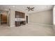 Spacious carpeted room features custom cabinets, a sink, and a wine fridge at 900 Green Oaks Pkwy, Holly Springs, NC 27540