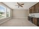 Expansive bonus room boasts custom cabinets, a sink, wine fridge, and bright windows at 900 Green Oaks Pkwy, Holly Springs, NC 27540