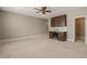 Large bonus room features custom cabinets, a sink, and a wine fridge at 900 Green Oaks Pkwy, Holly Springs, NC 27540