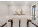 Dining area with wooden table, white chairs, and neutral wall decor at 900 Green Oaks Pkwy, Holly Springs, NC 27540