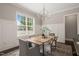 Dining room features a modern chandelier, large window, and stylish furnishings at 900 Green Oaks Pkwy, Holly Springs, NC 27540