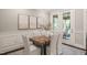 Dining area with wood table, white chairs, and doors leading to outdoor living space at 900 Green Oaks Pkwy, Holly Springs, NC 27540