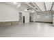 Spacious three-car garage with ample room for vehicles and storage, featuring bright lighting and clean floors at 900 Green Oaks Pkwy, Holly Springs, NC 27540