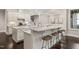 Elegant kitchen island featuring granite countertops and bar stools, adjoining dining area at 900 Green Oaks Pkwy, Holly Springs, NC 27540