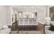 Open-concept kitchen with a large center island, stainless appliances, and breakfast bar seating at 900 Green Oaks Pkwy, Holly Springs, NC 27540