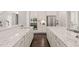 Spacious kitchen with dual sinks, stainless steel appliances, and elegant white cabinetry at 900 Green Oaks Pkwy, Holly Springs, NC 27540
