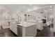 Well-lit kitchen with an island offering dining space connecting to living area at 900 Green Oaks Pkwy, Holly Springs, NC 27540