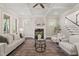 Bright living room with fireplace, large windows, and a glimpse of the staircase at 900 Green Oaks Pkwy, Holly Springs, NC 27540