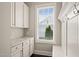 Mudroom with granite countertop, white cabinets, hooks, and bench at 900 Green Oaks Pkwy, Holly Springs, NC 27540