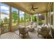 Relaxing screened porch with outdoor seating offering serene views of the well-manicured lawn and garden at 900 Green Oaks Pkwy, Holly Springs, NC 27540