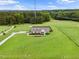 Aerial view of a home with sprawling green lawn, long driveway, and wooded surroundings at 9300 Lake Wheeler Rd, Fuquay Varina, NC 27526
