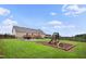 Expansive backyard with a playground, seating area, and lush green lawn offers ample space for recreation at 9300 Lake Wheeler Rd, Fuquay Varina, NC 27526