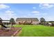 Large backyard features a swing set, playhouse, and green lawn at 9300 Lake Wheeler Rd, Fuquay Varina, NC 27526