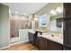 Well-lit bathroom with dual sink vanity, framed mirrors, and large walk-in shower at 9300 Lake Wheeler Rd, Fuquay Varina, NC 27526