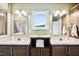 Beautiful bathroom with dual sinks, dark wood cabinets, and framed mirrors at 9300 Lake Wheeler Rd, Fuquay Varina, NC 27526