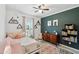 Bright bedroom features a queen bed, colorful decor, and window that create a whimsical and inviting space at 9300 Lake Wheeler Rd, Fuquay Varina, NC 27526