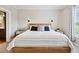 Bright bedroom with wooden frame bed, bedside tables, and lamps for a cozy feel at 9300 Lake Wheeler Rd, Fuquay Varina, NC 27526