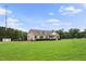 Exterior home view, expansive lawn, a welcoming front porch, and serene setting at 9300 Lake Wheeler Rd, Fuquay Varina, NC 27526