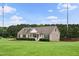 Home's front exterior with a well-kept lawn, neat landscaping, and cozy front porch at 9300 Lake Wheeler Rd, Fuquay Varina, NC 27526