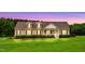 Charming home featuring a spacious front yard, manicured landscaping, and a welcoming covered porch at 9300 Lake Wheeler Rd, Fuquay Varina, NC 27526