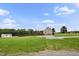 View of the home's exterior showing a spacious yard, shed, and driveway at 9300 Lake Wheeler Rd, Fuquay Varina, NC 27526