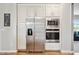 Stainless steel fridge, microwave, and oven nestled in white cabinets in this kitchen at 9300 Lake Wheeler Rd, Fuquay Varina, NC 27526