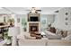 Bright living room featuring a cozy fireplace, ceiling fan, and neutral décor, perfect for relaxing at 9300 Lake Wheeler Rd, Fuquay Varina, NC 27526