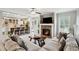 Inviting living room featuring a stone fireplace, plush seating, and an open layout to the kitchen at 9300 Lake Wheeler Rd, Fuquay Varina, NC 27526