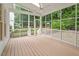 Beautiful screened back porch with wood flooring offers an excellent view of the backyard at 9425 Brimstone Ln, Raleigh, NC 27613