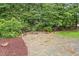 A stone patio and firepit nestled in a serene backyard setting, perfect for outdoor relaxation at 9425 Brimstone Ln, Raleigh, NC 27613