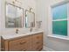 Bathroom with double vanity, marble countertop, modern faucets, two mirrors and natural light at 9425 Brimstone Ln, Raleigh, NC 27613